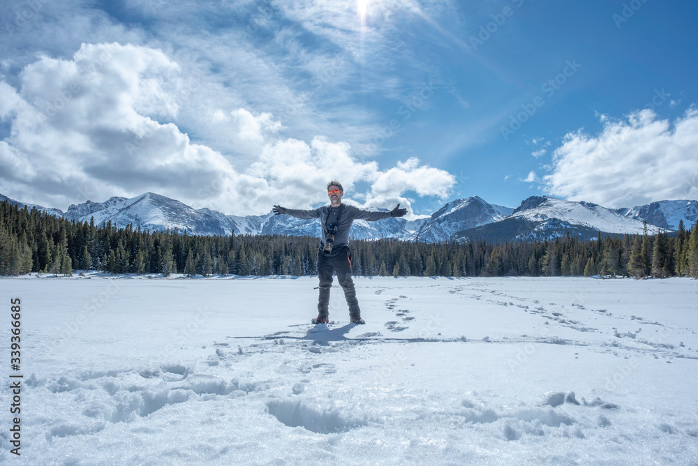 Photographer on frozen alpine lake