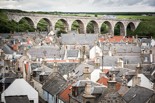 Old croft houses in Cullen, fishing village on Moray Firth, Scotland. Cullen Viaduct in the background, old roofs and chimneys