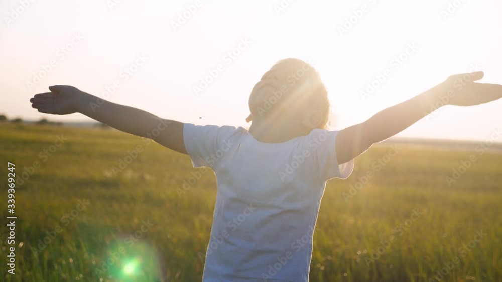 small child hands drawn to heaven concept happy family religion. little boy closed his eyes spread his lifestyle arms to the sides on the nature in the park at sunset slow motion video small child hands drawn to heaven concept happy family religion. little boy closed his eyes spread his lifestyle arms to the sides on the nature in the park at sunset slow motion video