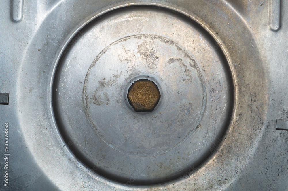 Metal background. large bolt in the middle of iron tank Metal background. large bolt in the middle of iron tank