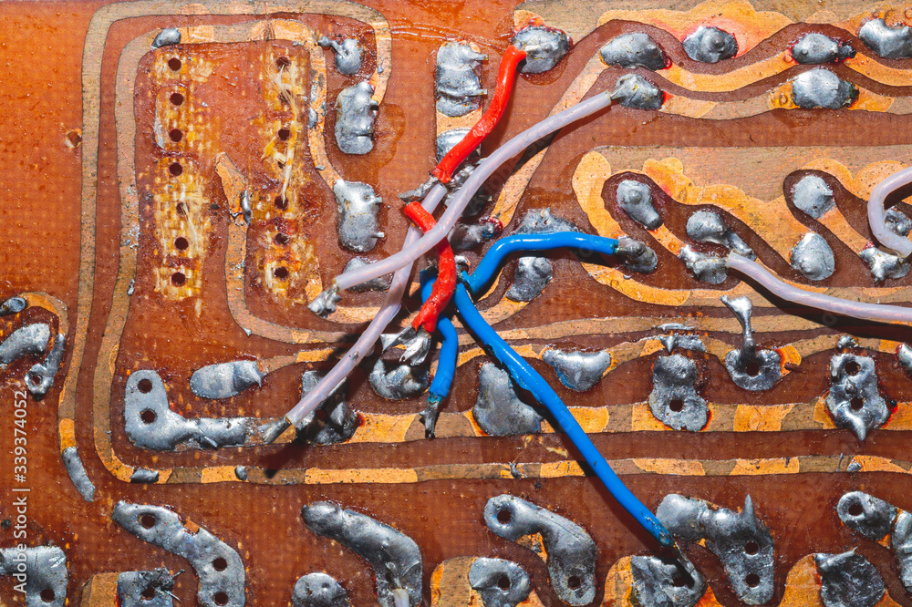 Handmade circuit board with connections and traces. colorful wires