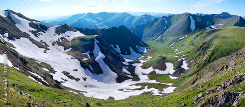 Beautiful mountain valley  snow and greens on the slopes  mountain panorama  Altay