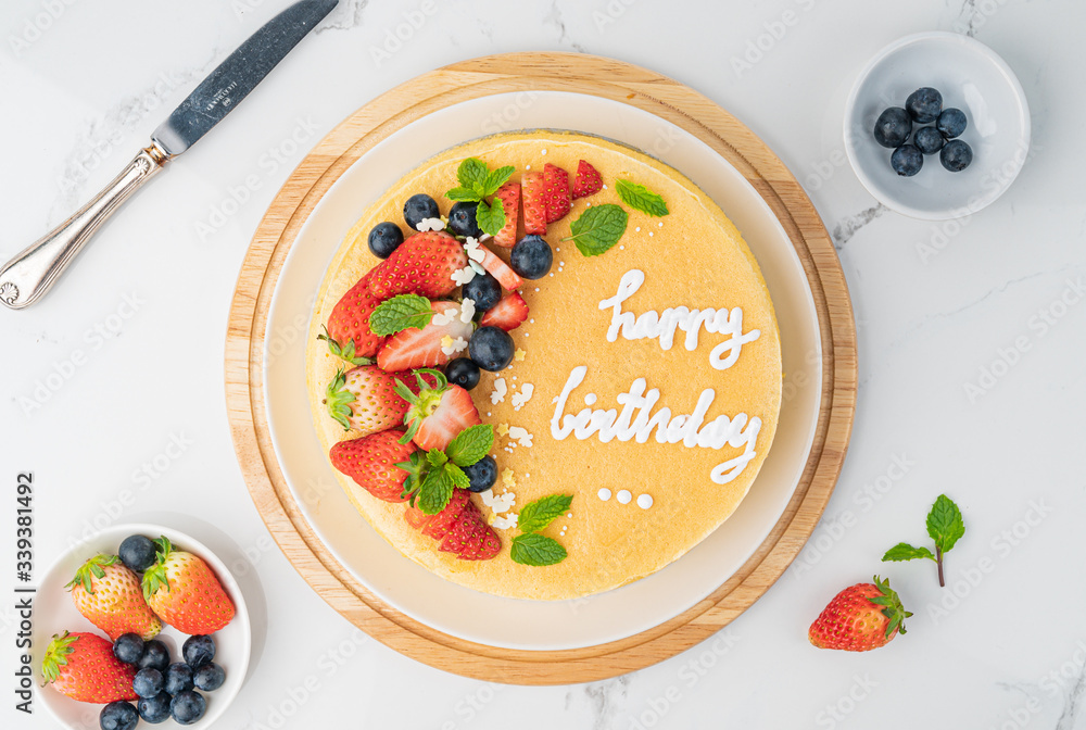 Happy birthday fresh fruit cheese cake with Happy birthday on cake concept with strawberry kiwi fruit cake. Food concept.