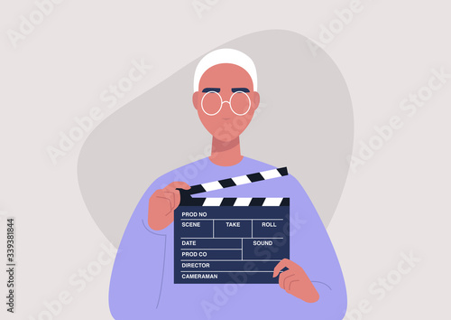 Movie production, young male character holding a clapper board, video industry