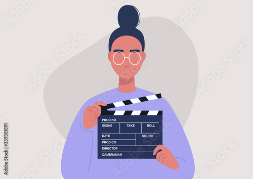 Movie production, young female character holding a clapper board, video industry