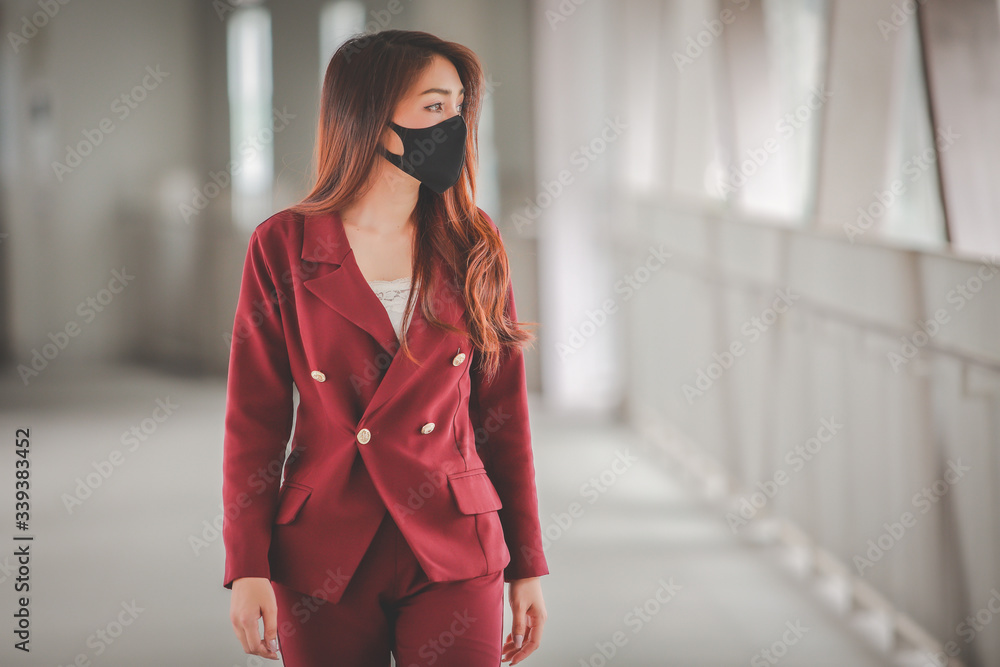 Fototapeta premium Asian woman wearing mask for protect pm2.5 and cough with Covid-19 virus outbreak in public.