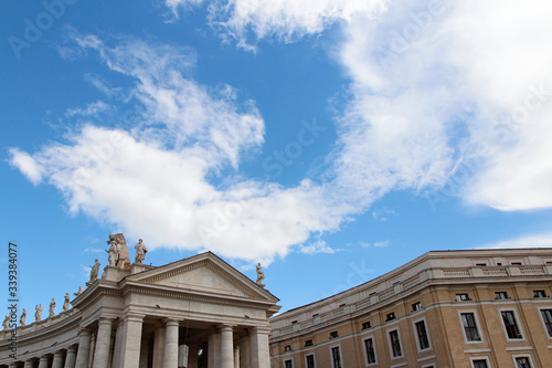 A group of Saint Statues on the colonnades of St Peter s Square with blue sky and clouds in Vatican City  Rome  Italy