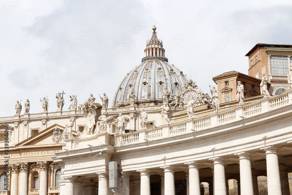 A group of Saint Statues on the colonnades of St Peter's Square with dome in Vatican City, Rome, Italy
