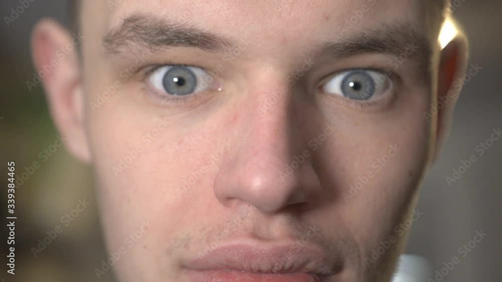 A Handsome Guy's Face With Serious Expression And Eyes Wide Open - Closeup Shot A Handsome Guy's Face With Serious Expression And Eyes Wide Open - Closeup Shot