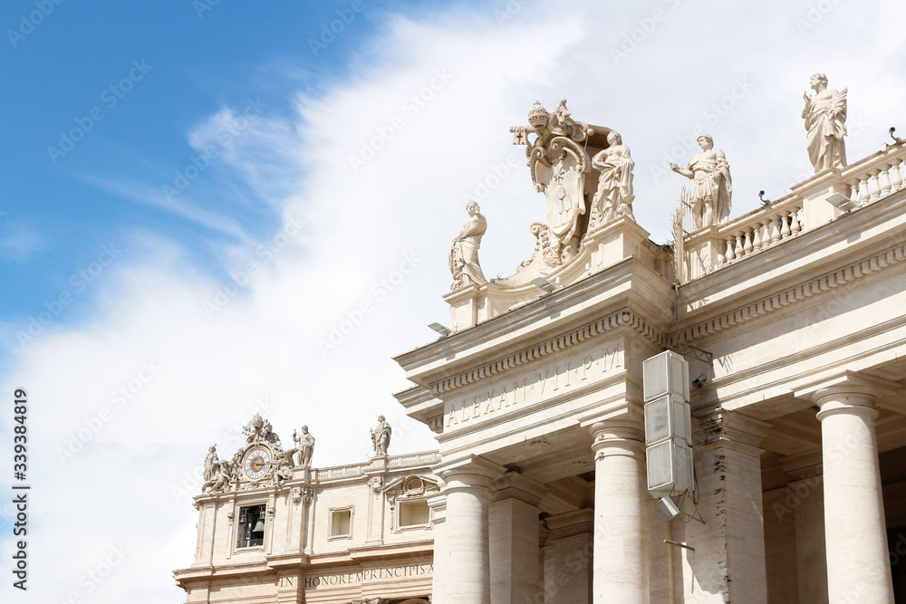 A group of Saint Statues on the colonnades of St Peter's Square with blue sky and clouds in Vatican City, Rome, Italy