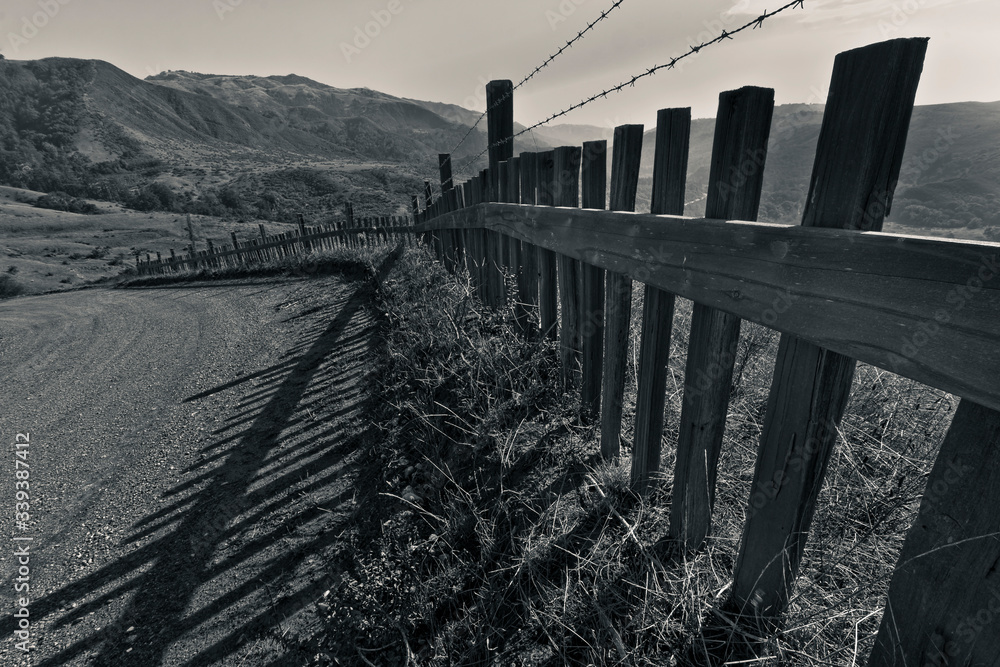 Rolling Hills and Old Wooden Fence  Leading to the Santa Lucia Range, Old Coast Rd, Big Sur, California, USA
