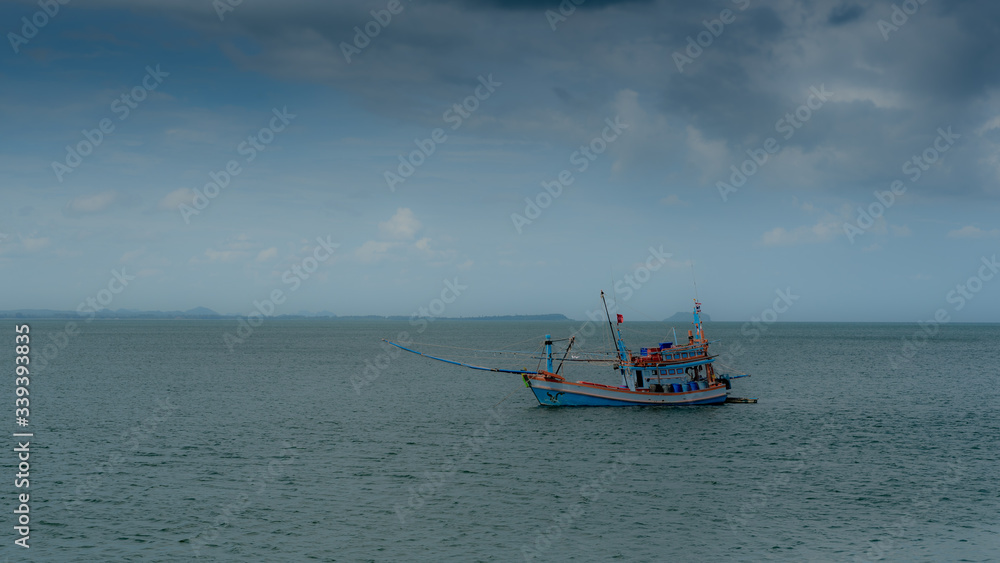 Traditional Thai fishing boat with outriggers out Traditional Thai fishing boat with outriggers out