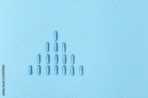 Pharmaceutical medicine pills  capsule lie on blue surface  virus distribution. Medical  pharmacy and healthcare concept. Copy space.