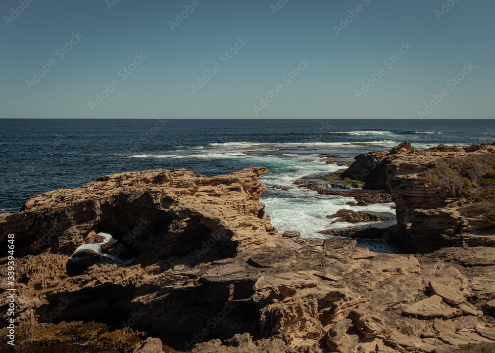 Landscape showing the sea water meeting shaped rocks on Rottnest Island, Australia