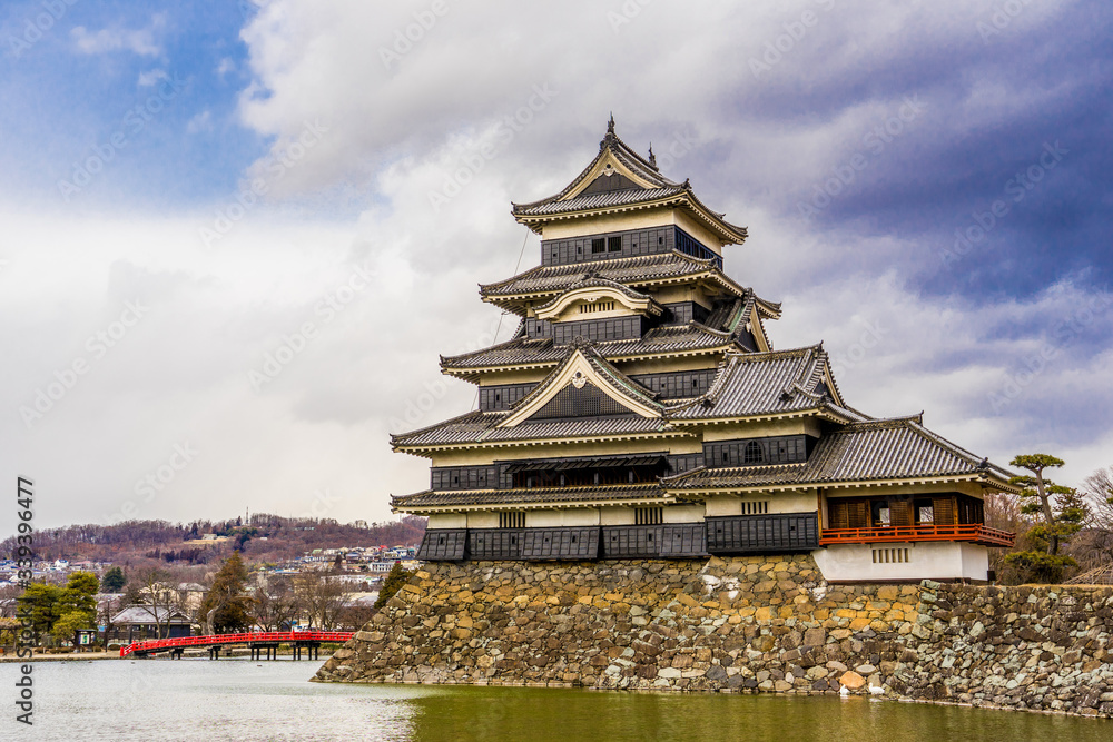 Matsumoto Castle (Matsumoto-jo) and red bridge in eastern Honshu, Matsumoto-shi, Chubu, Nagano, Japan. a Japanese premier historic castles Matsumoto Castle (Matsumoto-jo) and red bridge in eastern Honshu, Matsumoto-shi, Chubu, Nagano, Japan. a Japanese premier historic castles