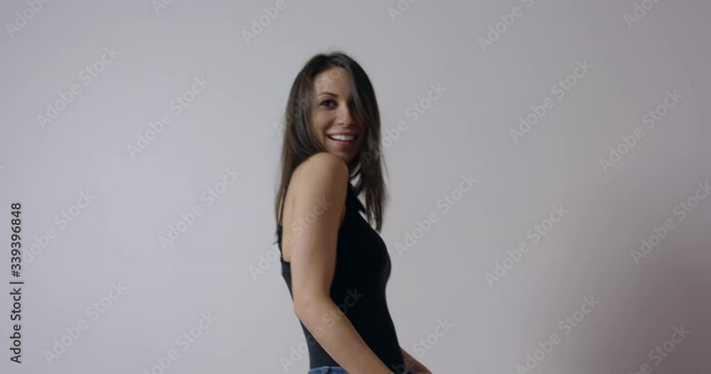 Woman side dancing in front of white wall Woman side dancing in front of white wall