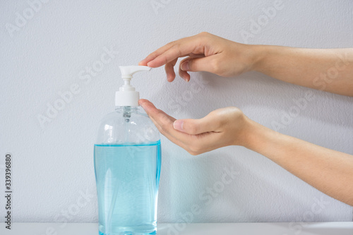 Close-up hands of women using alcohol antiseptic gel for washing hands on white background in hygienic concept