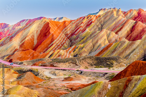 Amazing scenery of Rainbow mountain and blue sky background in sunset. Zhangye Danxia National Geopark, Gansu, China. Colorful landscape, rainbow hills, unusual colored rocks, sandstone erosion