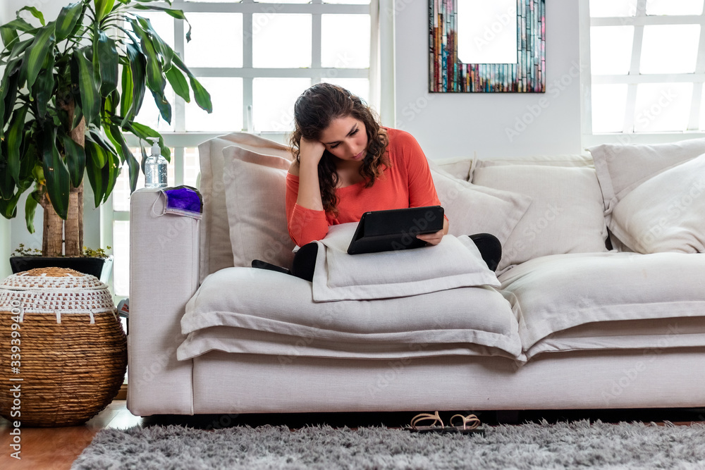 Real woman bored of watching television at home. Covid 19 coronavirus quarantine Real woman bored of watching television at home. Covid 19 coronavirus quarantine