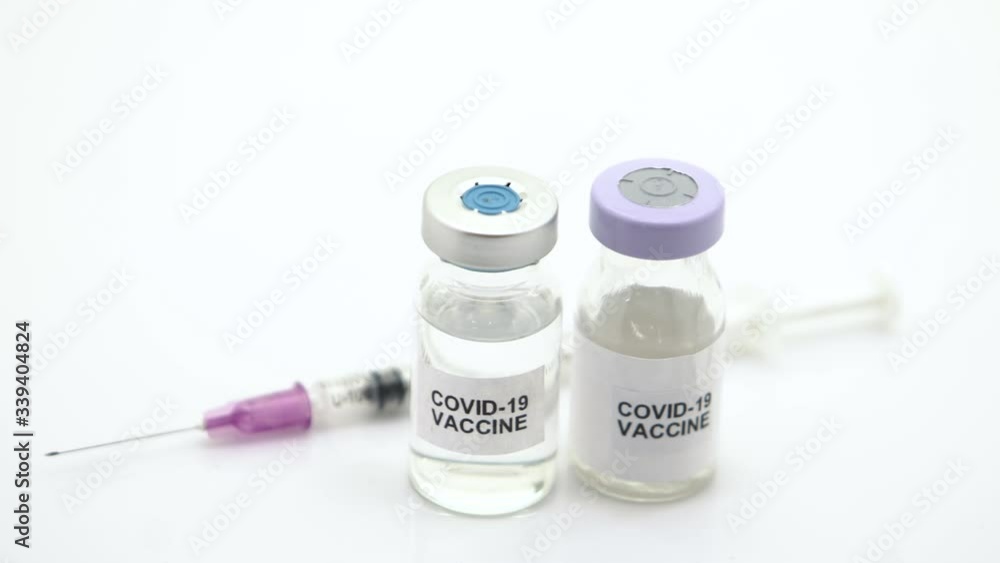 The vaccines and syringes are used to prevent vaccination from COVID-19 on a white background. The camera moves from right to left. The vaccines and syringes are used to prevent vaccination from COVID-19 on a white background. The camera moves from right to left.