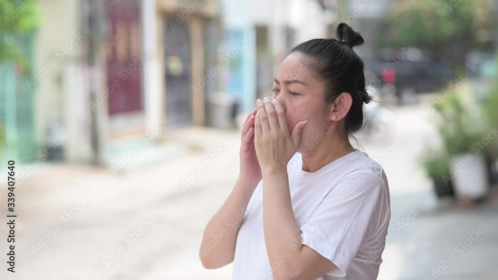 Asian pregnant women wearing white shirts standing coughing in front of the house, idea and concept for coronavirus, covid19 Asian pregnant women wearing white shirts standing coughing in front of the house, idea and concept for coronavirus, covid19