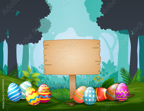 Easter eggs with wooden sign  in the middle of dark forest