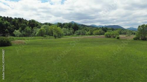 Wallpaper Mural Fast drone flies low over green grass toward river and turns quickly right Torontodigital.ca