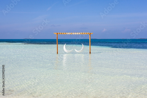 The beautifull beach of Dhangethi, maldives. Known for Diving, day tour for resort and this beautifull beaches and the swing in the water photo