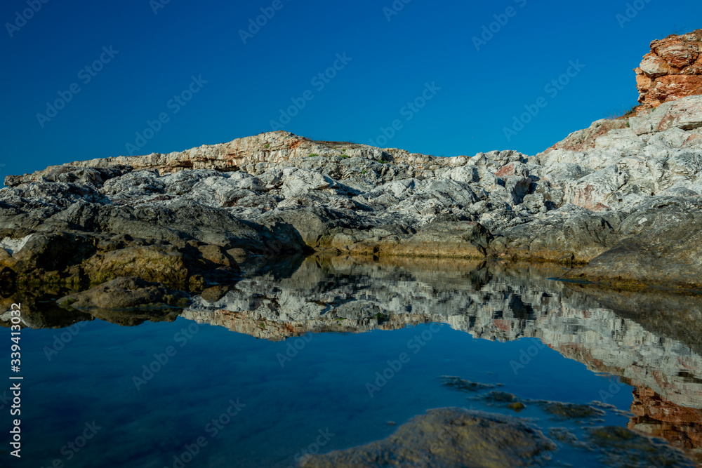 Huge rocks reflected in the water