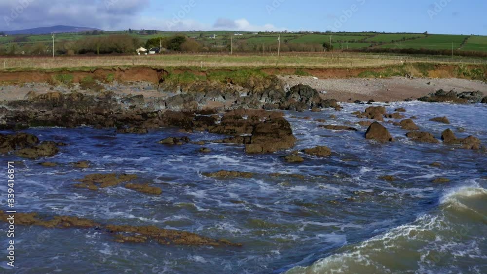 Birds eye view flying over ocean waves near sea shore in Ireland, low altitude Birds eye view flying over ocean waves near sea shore in Ireland, low altitude