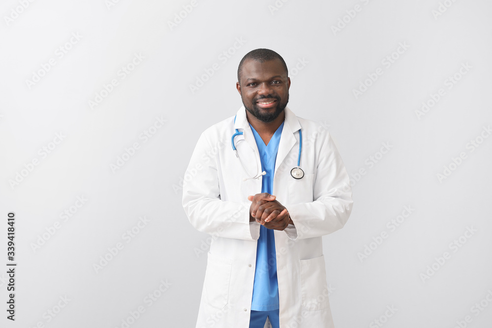 African-American doctor on light background African-American doctor on light background