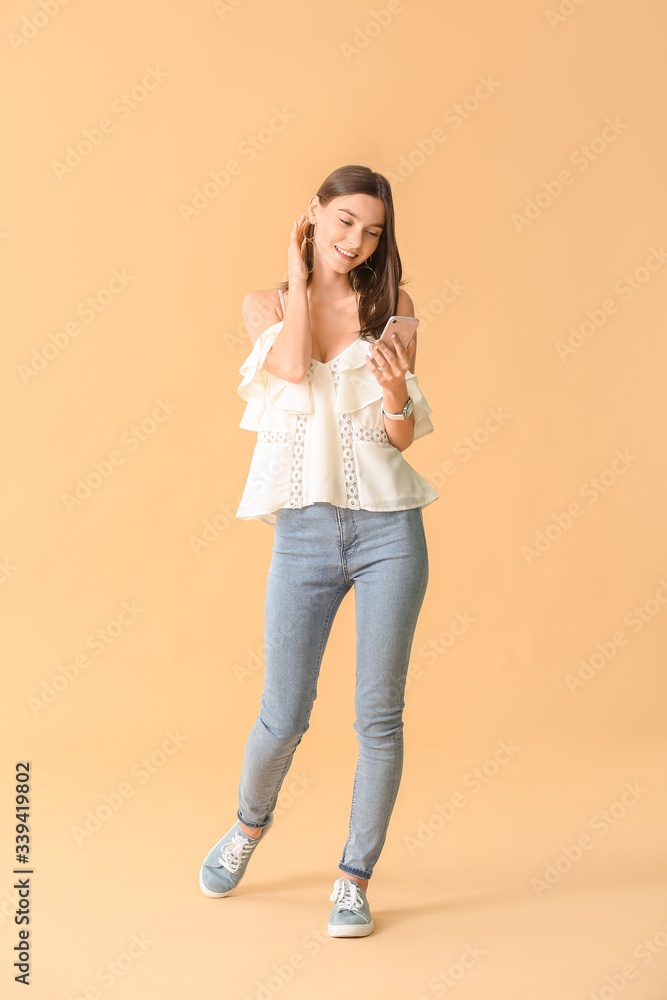 Beautiful young woman with mobile phone on color background Beautiful young woman with mobile phone on color background