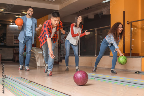 Friends playing bowling in ...