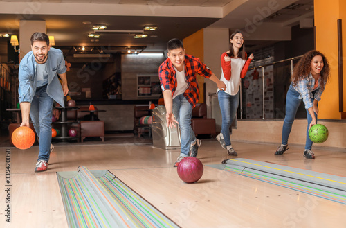 Friends playing bowling in ...