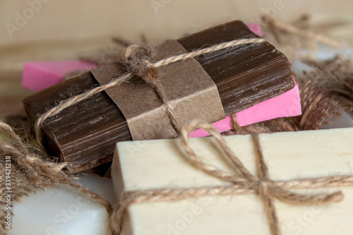 Handmade multi-colored soap on a wooden background.