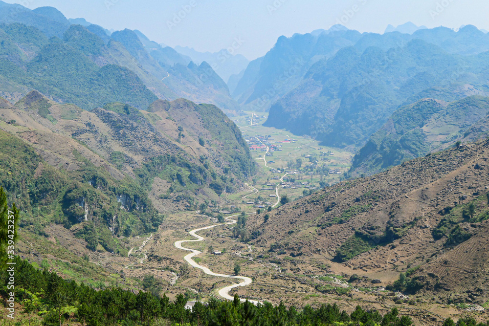 Fototapeta premium Road in the green mountains with green forest.