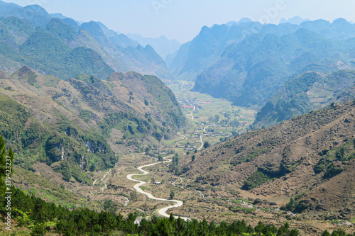 Road in the green mountains with green forest.