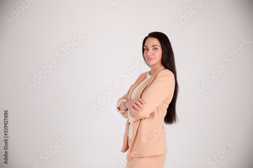 Successful business woman on grey background with copy space. Director in beige suit