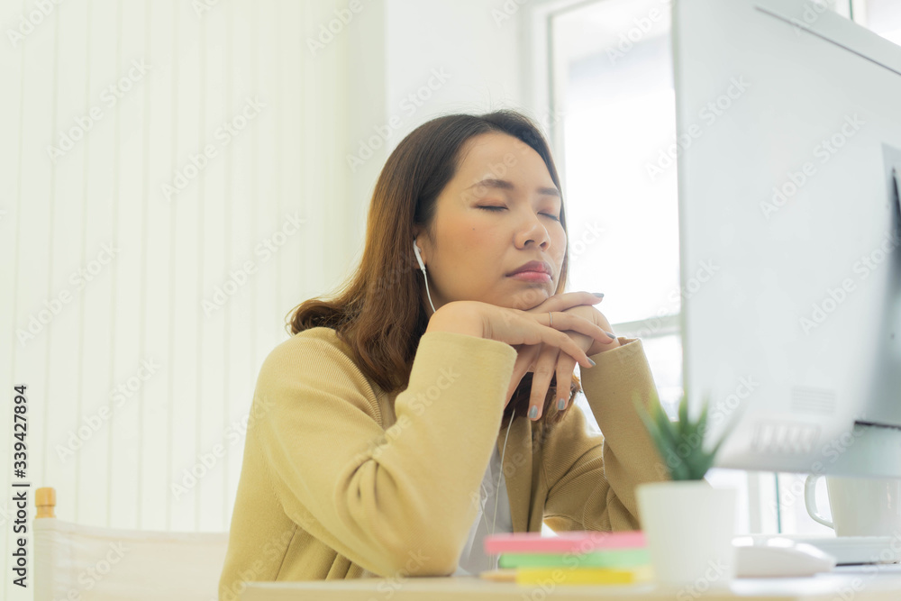 close up young employee woman sleeping at desktop table after feeling asleep in the afternoon for work from home and quarantine time concept close up young employee woman sleeping at desktop table after feeling asleep in the afternoon for work from home and quarantine time concept