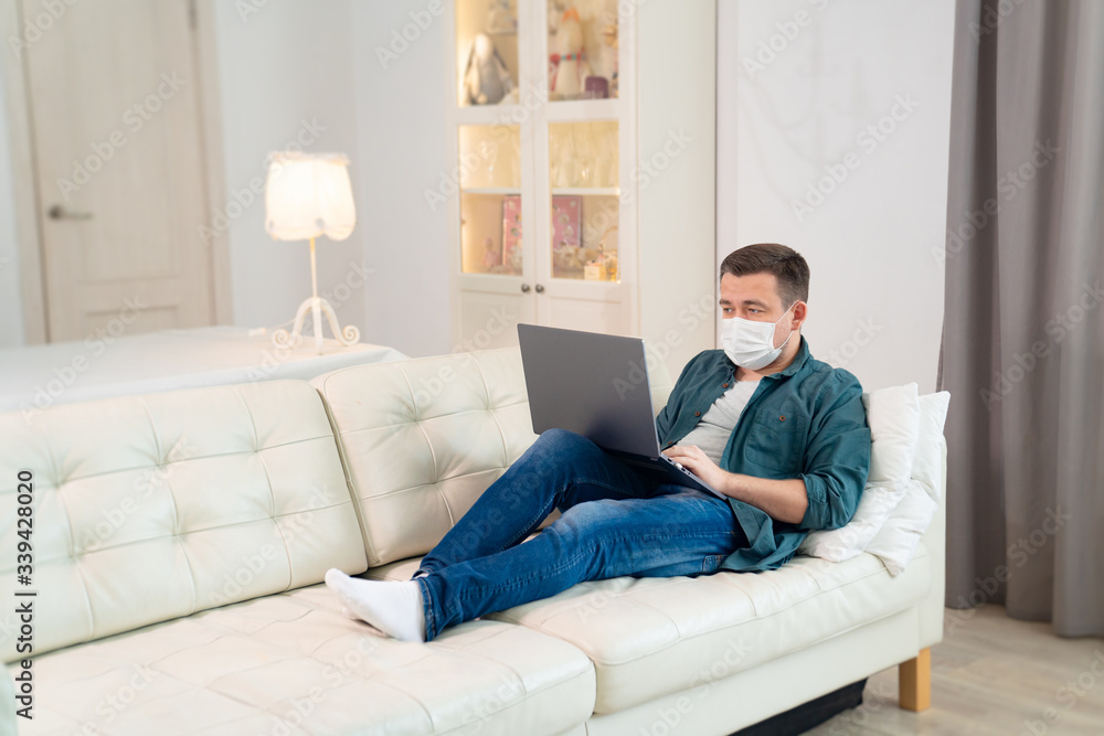 freelancer in medical mask working on couch freelancer in medical mask working on couch