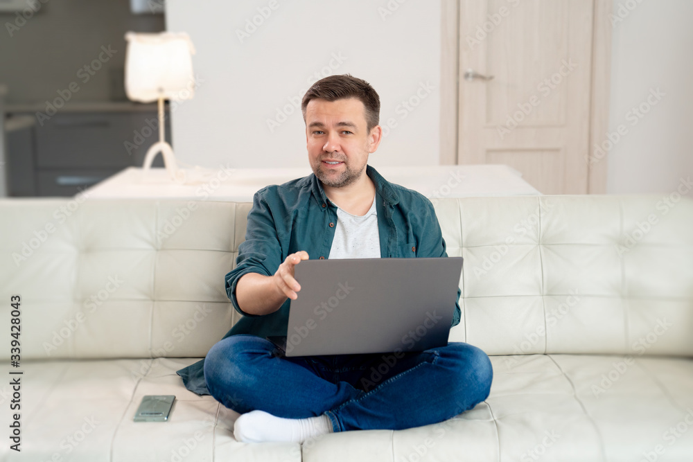 male blogger working online sitting on the couch. male blogger working online sitting on the couch.
