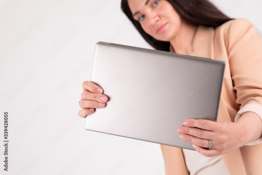 Successful business woman on grey background with copy space laptop mock up Successful business woman on grey background with copy space laptop mock up