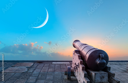 Fototapeta Ramadan Concept - Ramadan kareem cannon with crescent - Night sky with moon in t