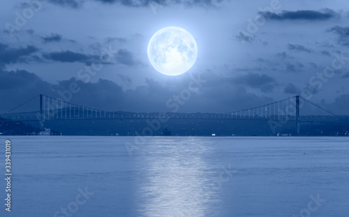 Bosphorus bridge at sunset - Istanbul, Turkey - Night sky with moon in the clouds "Elements of this image furnished by NASA