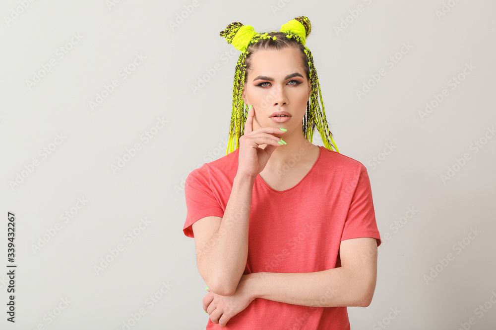Portrait of young transgender woman on light background Portrait of young transgender woman on light background