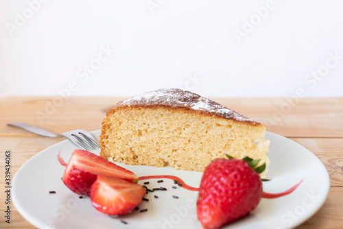 Fototapeta Naklejka Na Ścianę i Meble -  Delicious slice of cake decorated with strawberries. pastry concept.