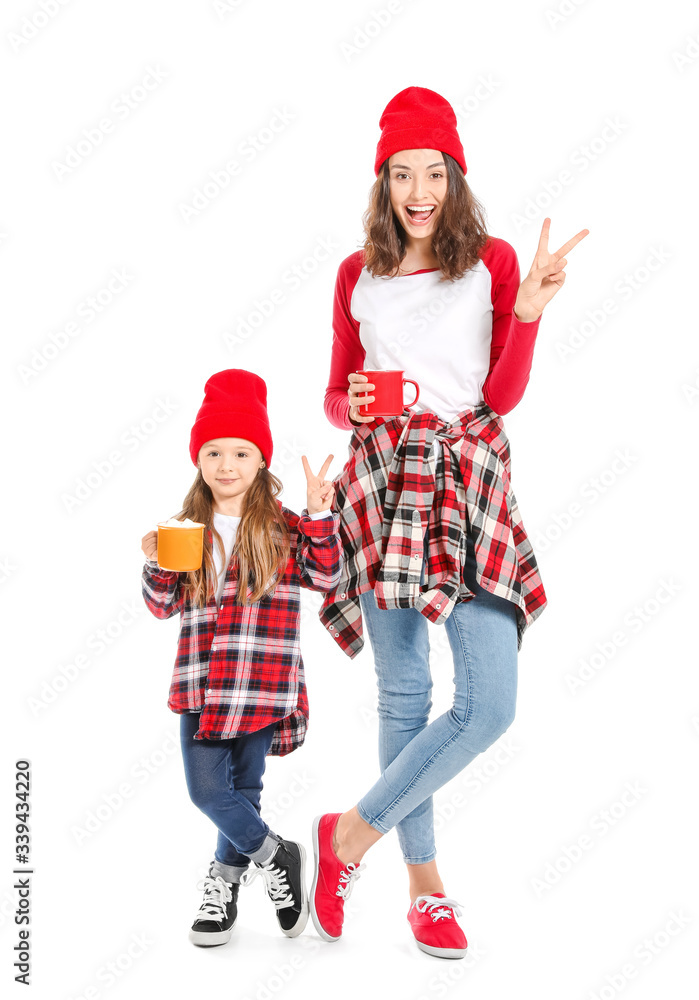 Woman and her little daughter with tasty cocoa drink on white background Woman and her little daughter with tasty cocoa drink on white background