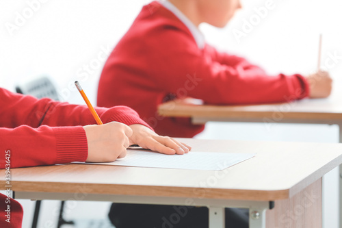 Pupils passing exam at school