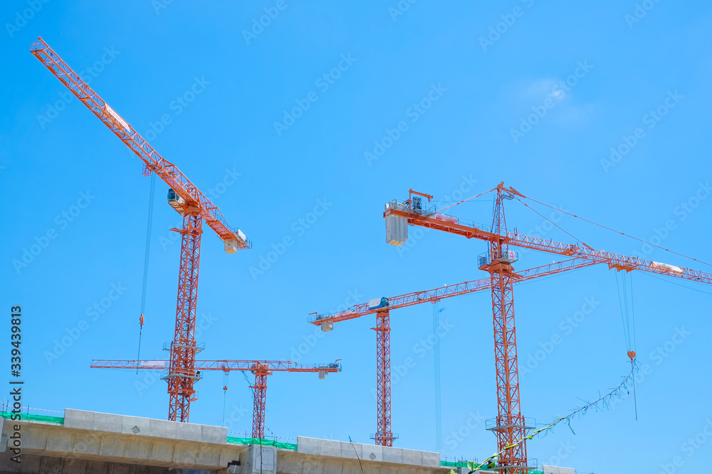Construction building site with cranes against blue sky Construction building site with cranes against blue sky