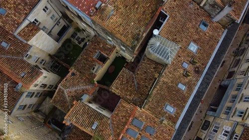 Drone footage over Bordeaux city on a sunny day, footage include old building and people are enjoying walking. photo